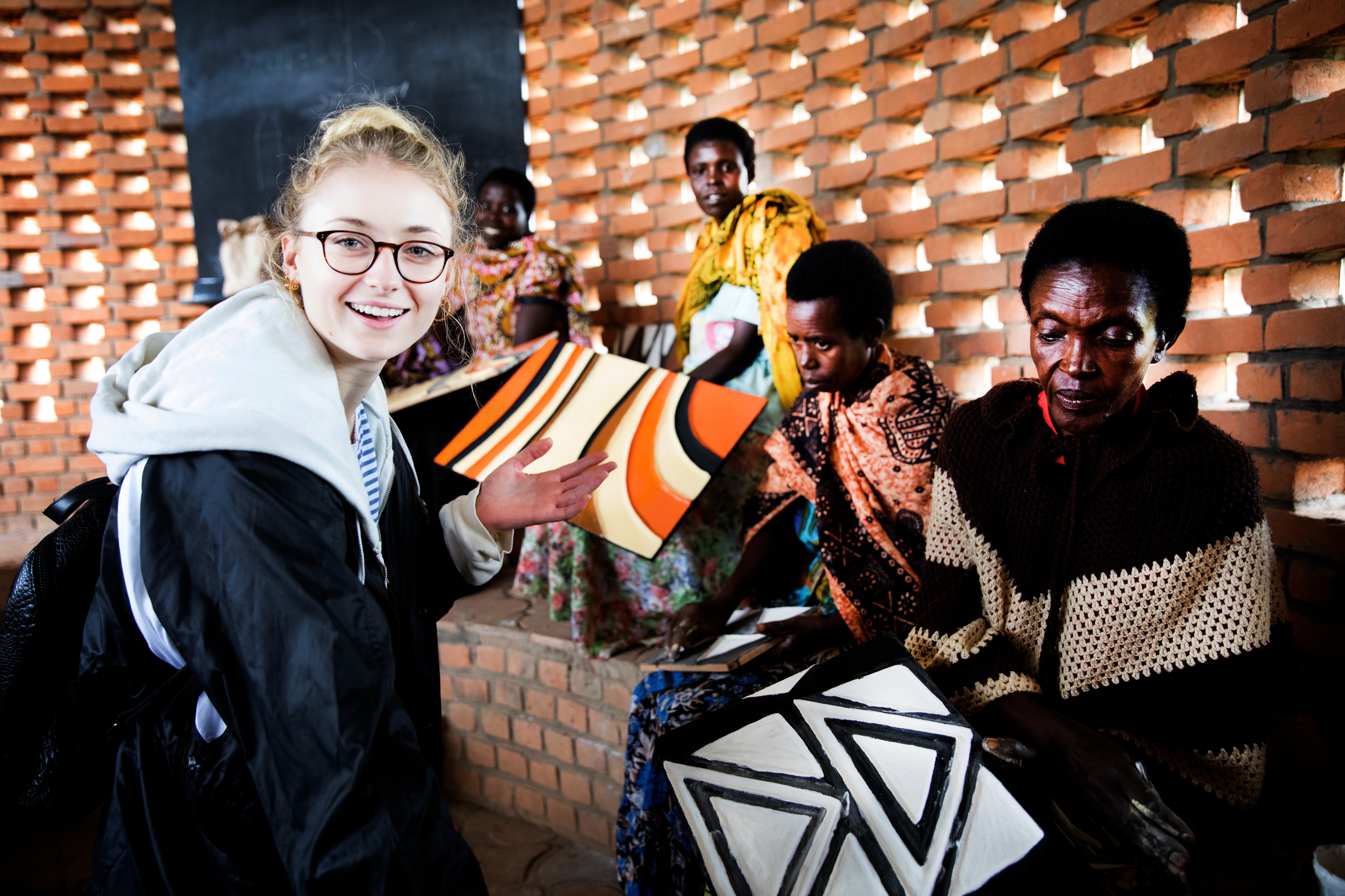 Sophie Turner meets women producing traditional Rwandan artwork. Photo: Hazel Thompson