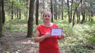 Hidajete from Kosovo holding her #MessageToMySister: "You are not alone." Photo: Women for Women International