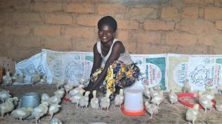 Josephine with her poultry. Photo credit: Women for Women International