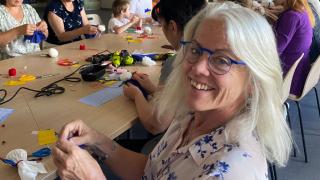 Laurie participates in an art workshop with Ukrainian women. Photo credit: Women for Women International