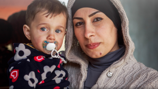 Eman, a Syrian refugee and graduate of our Stronger Women, Stronger Nations programme, with her son at their home in Iraq. Photo: Women for Women International