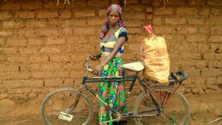 Mukunde uses her bicycle as a taxi and to help her carry more vegetables to the market in South Kivu, the Democratic Republic of Congo. Photo: Women for Women International