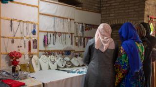 Ferhana in her shop in Afghanistan, where she employs other women. Photo: Women for Women International