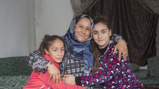 Shireen and her daughters. Shireen is one of our programme graduates in Erbil, Iraq. She has turned her sewing skills into a thriving business and can now support herself and her family. Credit: Alison Baskerville