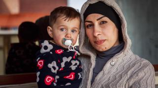 Eman, a graduate of our programme in Iraq, with her son at their home. They joined our programme in Erbil, Iraq, after leaving their home in Syria. Photo: Emily Kinskey