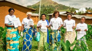 Angelique, graduate of our Stronger Women, Stronger Nations programme and Change Agent in the Democratic Republic of the Congo. Pictured with other Change Agents in her community who are campaigning for more women to own land, all holding land titles in their own names. Photo: Sighted Design