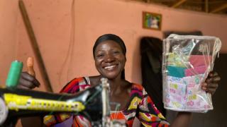 Grace with her sewing machine and reusable period pads. 