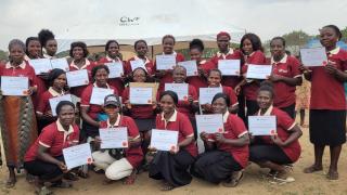 Blessing (back row, second from the right) celebrates her graduation from the Stronger Women, Stronger Nations programme in May 2024, pictured alongside her group sisters.