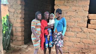 Blessing with her children. Photo: Women for Women International