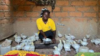 Blessing with her birds. She looks after them using knowledge gained during vocational training modules in the Stronger Women, Stronger Nations programme.