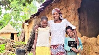 Grace outside her home, pictured with two of her six children. She says, "The first is a boy named Victor, who is 28 years old and is into farming, the second is Martina who is 25 years old and is married with 3 children. Sunday is 23 years old and lives in Abuja, and Faith is the fourth child and is 17 years old. She attends the government secondary school in Vwang. My last daughter is 12 years old while Moses, the last child, is 9 years old – and they both attend the primary school in Fwil"