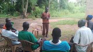 Stephen Batali speaking to men during a training session in Longamere village, Yei County. Photo: Women for Women International