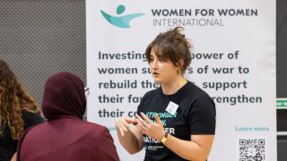 Our team hosted a booth after the panel, giving students the chance to ask questions, learn more about the organisation and explore opportunities in volunteering and advocacy. Photo credit: Mulberry Schools Trust.