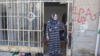 Woman in doorway looking to the side and smiling