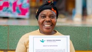Faida shows her certificate during the Women for Women International graduation ceremony in Bukavu, DRC. Photo: Patrick Luhiriri