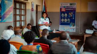 Vianney Dong speaking with community leaders and representatives about the Ebola response. Photo: Alexi Daudi
