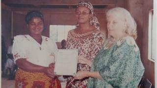 Two members of the WfWI Nigeria team handing a certificate to a programme participant