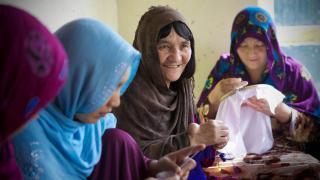 The Friends of Rights Association, Fatima, 60, with hand tumor, knitting