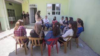 A group of programme participants in Iraq receive relaxation therapy. We have built strong partnerships with organisations who can offer psycho-social support, counselling, legal aid or shelter. Photo: Alison Baskerville