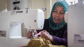 Najma practices sewing at the Warvin center in Debaga camp in Erbil, Iraq. Photo: Emily Kinskey