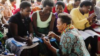A Women for Women International - Rwanda trainer teaches programme participants techniques for saving. Photo: Serrah Galos 