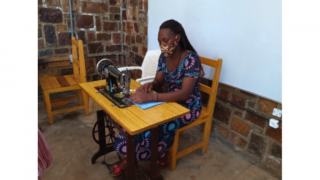 Jeanette, a graduate of the program in Rwanda, sewing masks