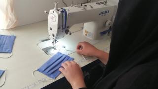 Hasiba said, “I was sewing traditional Kurdish clothes for my children when they wanted to go and play in a garden near my house. So, I decided to sew them masks.” Photo: Women for Women International