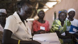 Awate, who was displaced by conflict in South Sudan, takes attendance at a Women for Women International meeting. Photo: Charles Atiki Lomodong