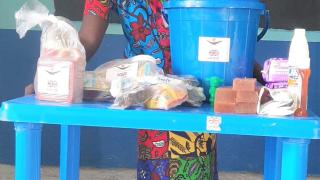 Saratu with her emergency package of hygiene items and food, provided during the COVID-19 lockdown with support from UK aid from the British people. Photo: Women for Women International