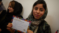 One of our programme participants in Iraq holding her #MessageToMySister from a supporter in Norway. Photo: Women for Women International 