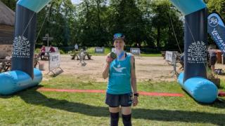 Natalie at the finish line of her ultramarathon