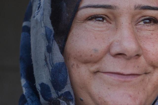 Woman Smiling looking to the right of the camera
