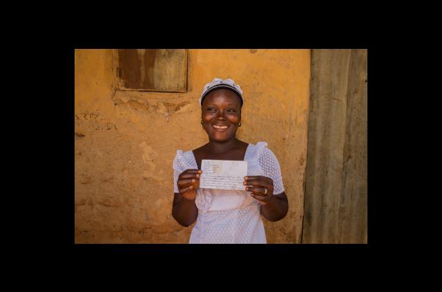 Faith Mathew holding a letter from her sponsored sister 